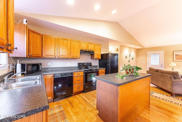 kitchen with sink, a center island, black appliances, plenty of natural light, and light wood-type flooring