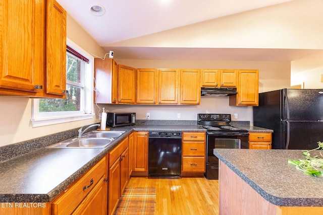 kitchen with lofted ceiling, sink, light hardwood / wood-style flooring, and black appliances