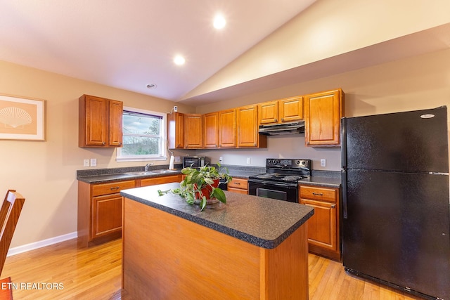 kitchen featuring a kitchen island, lofted ceiling, sink, light hardwood / wood-style floors, and black appliances