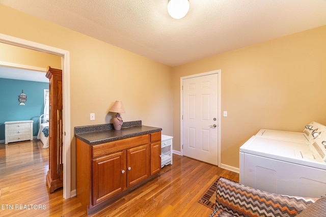 laundry room with dark hardwood / wood-style floors, independent washer and dryer, and a textured ceiling