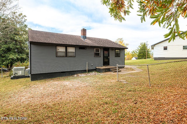 rear view of house featuring a lawn