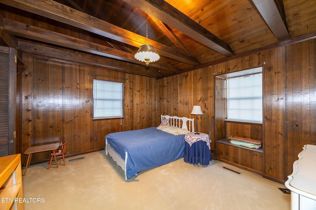 bedroom with lofted ceiling with beams, wood walls, wood ceiling, and light carpet