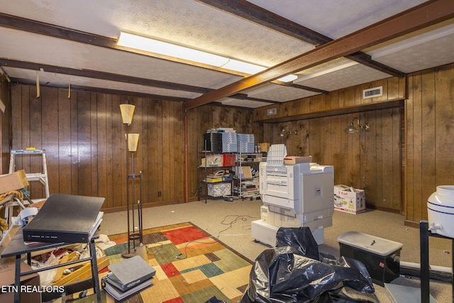 basement featuring carpet flooring and wood walls