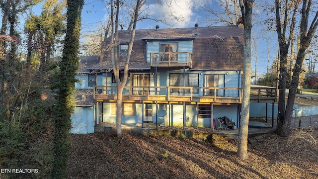 back of house featuring a balcony