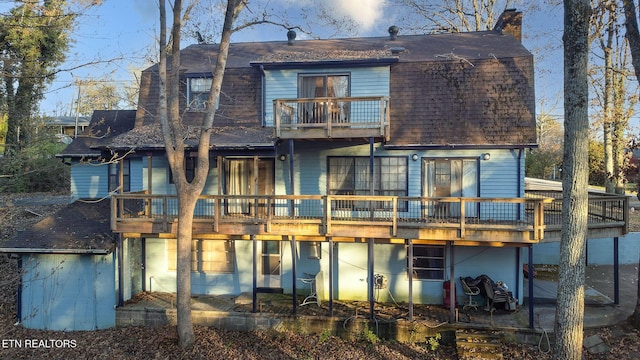 rear view of house featuring a balcony