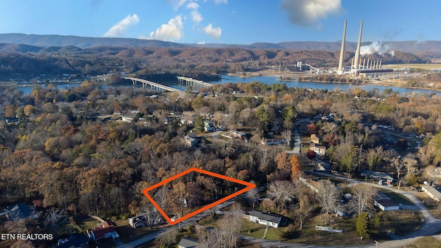 birds eye view of property with a water and mountain view