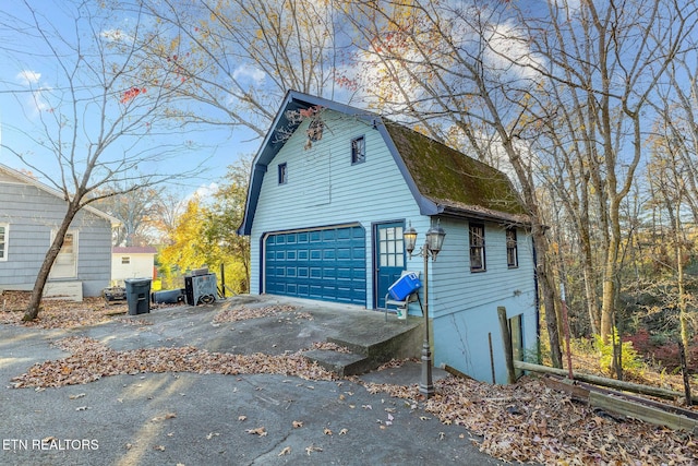 view of property exterior featuring a garage