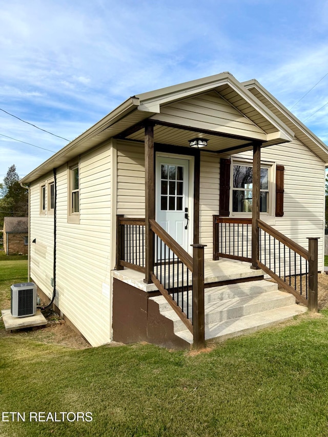 doorway to property featuring cooling unit and a yard