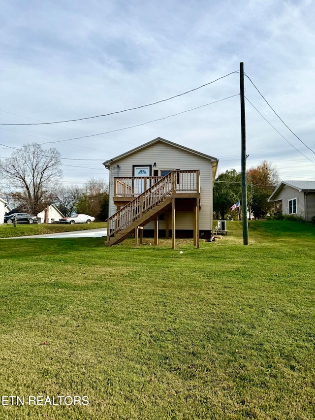 back of property featuring a yard, a wooden deck, and central air condition unit