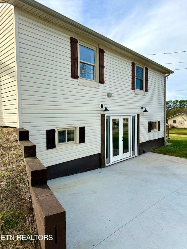 rear view of house featuring a patio and french doors