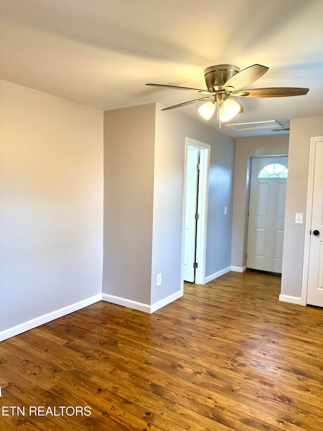 unfurnished room featuring ceiling fan and dark wood-type flooring