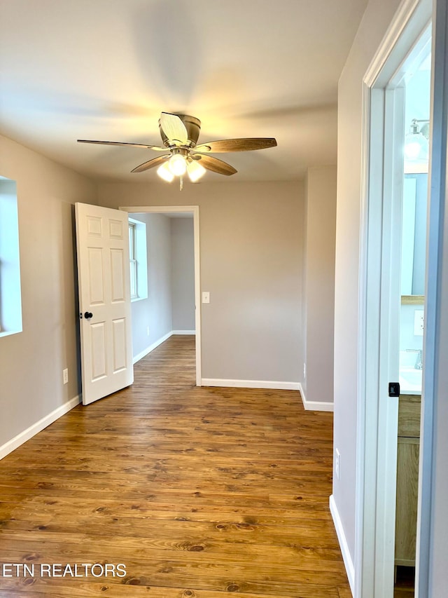 empty room featuring hardwood / wood-style flooring and ceiling fan