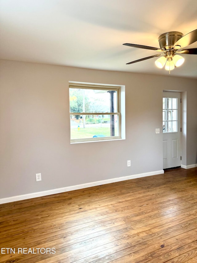 unfurnished room with hardwood / wood-style flooring, a wealth of natural light, and ceiling fan