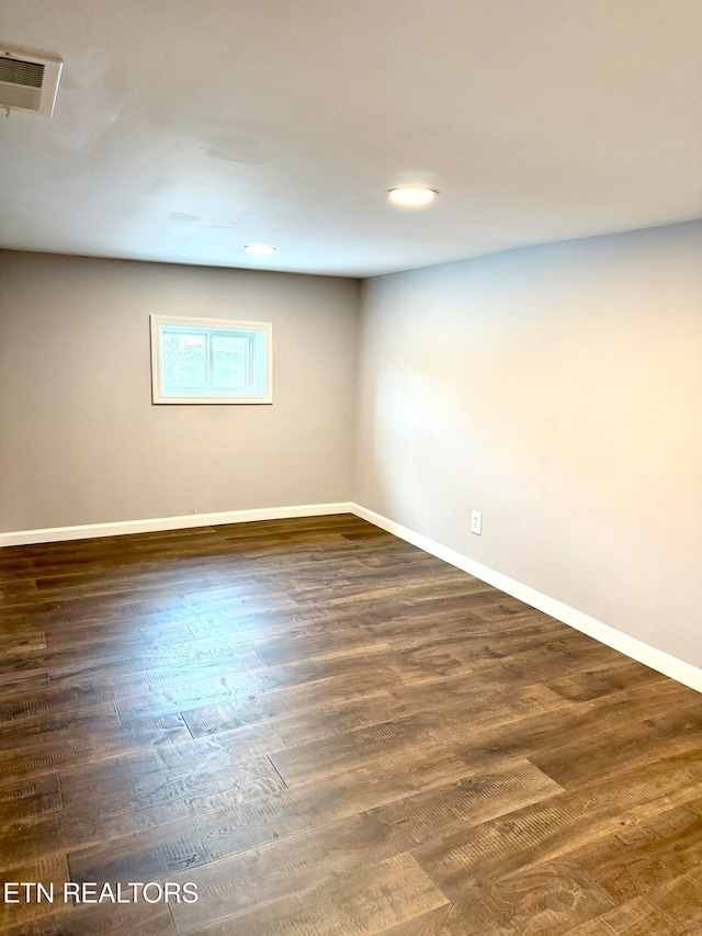 spare room with dark hardwood / wood-style flooring