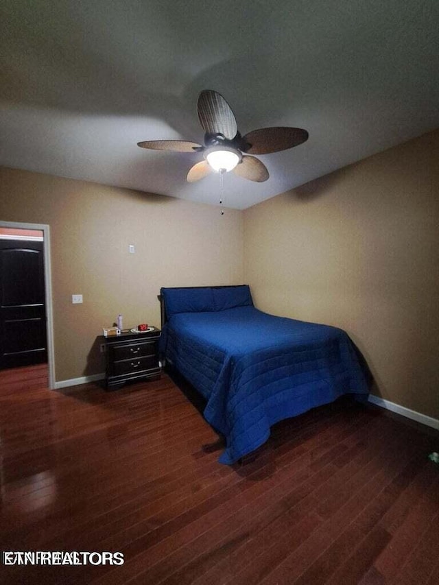 bedroom featuring dark hardwood / wood-style flooring and ceiling fan