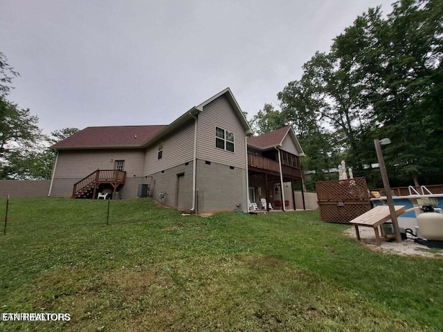 view of property exterior with cooling unit, a yard, and a wooden deck