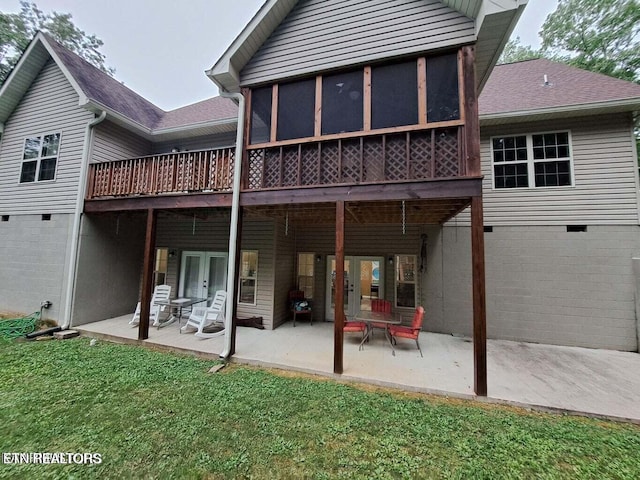 rear view of property with a yard, a patio, and a deck