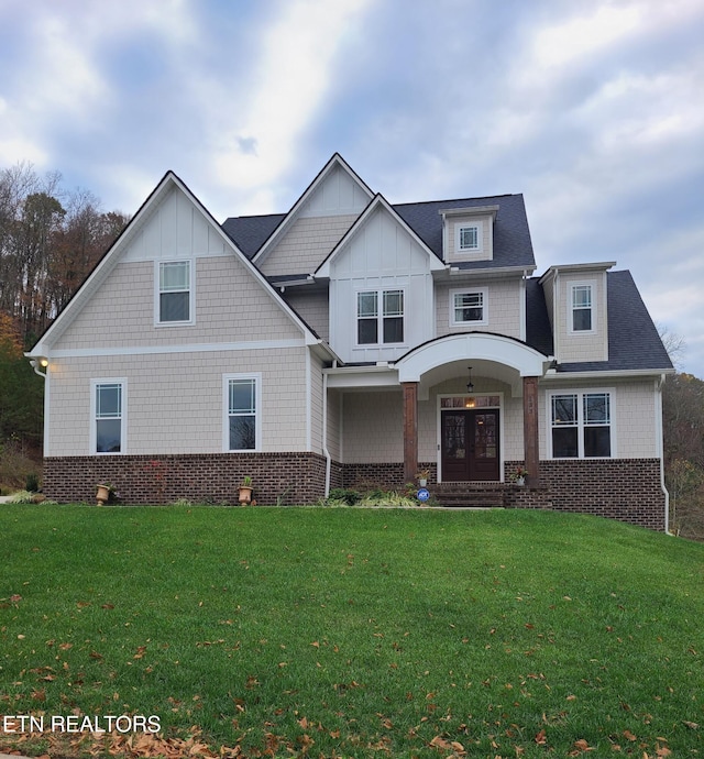 craftsman-style home featuring french doors and a front yard