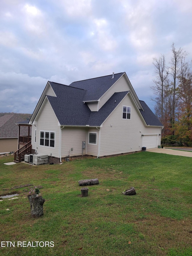 view of property exterior with a yard and a garage