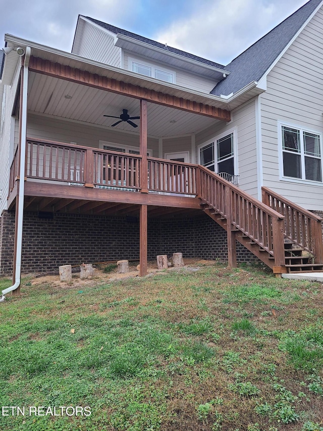 exterior space with stairway, a wooden deck, and a yard