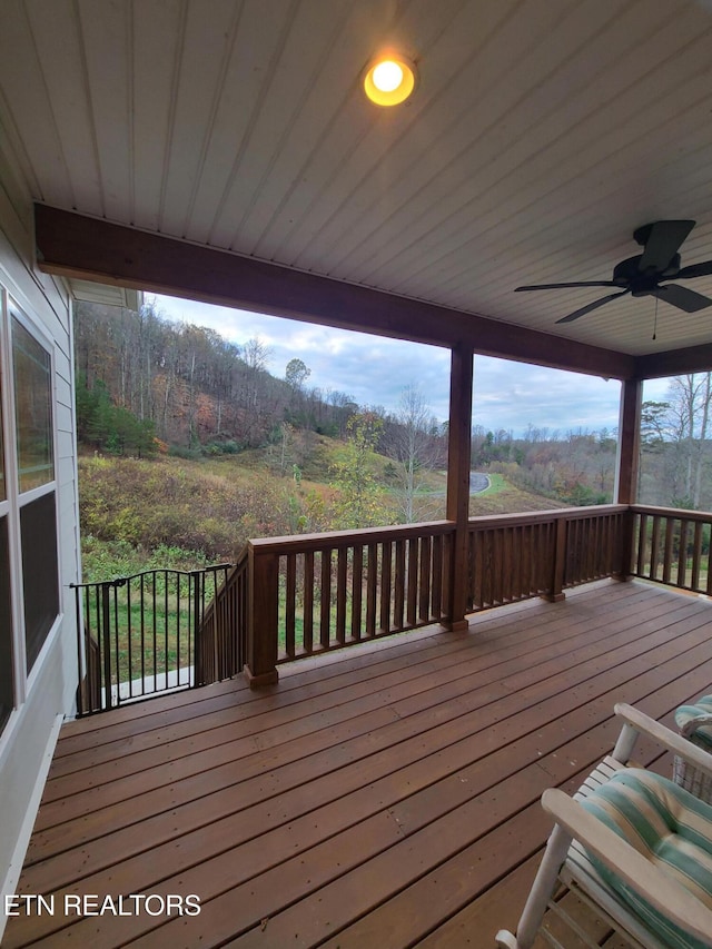 wooden terrace with a ceiling fan