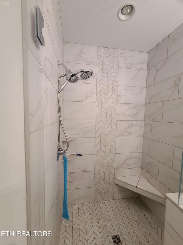 full bathroom with a tile shower