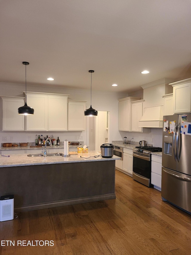 kitchen with stainless steel appliances, dark wood-style flooring, and white cabinetry