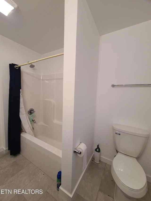 bathroom with tile patterned floors, toilet, shower / bath combination, and baseboards