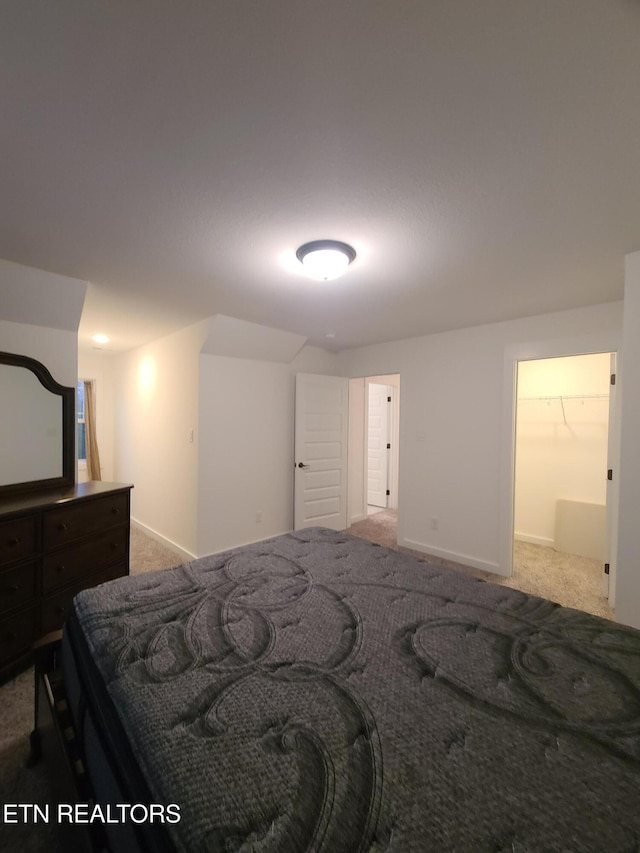 carpeted bedroom featuring baseboards