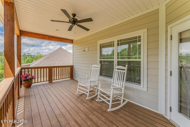 deck with a ceiling fan and a porch