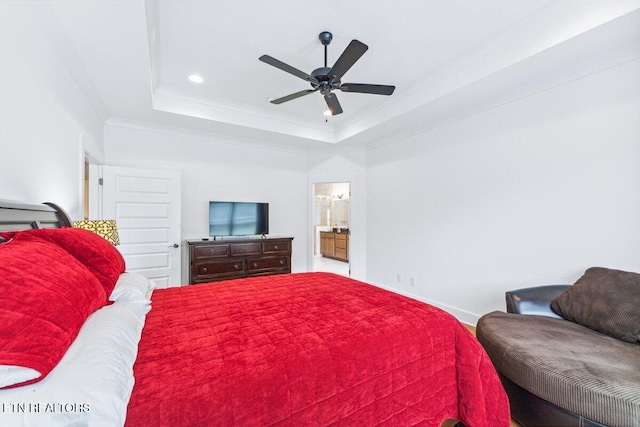 bedroom featuring ensuite bath, recessed lighting, crown molding, a tray ceiling, and baseboards