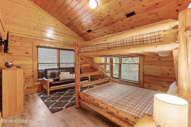 bedroom with wood-type flooring, high vaulted ceiling, wood walls, and wood ceiling