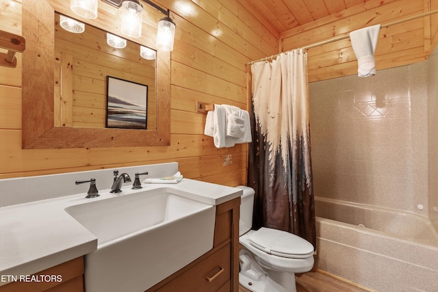 full bathroom with wood walls, vanity, shower / tub combo, and toilet