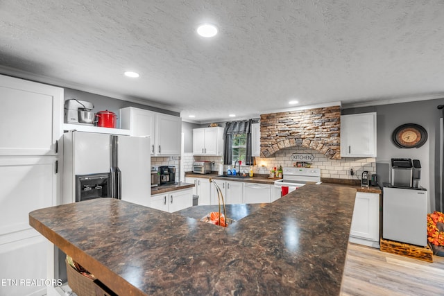 kitchen featuring a textured ceiling, light wood-type flooring, white cabinetry, and electric stove