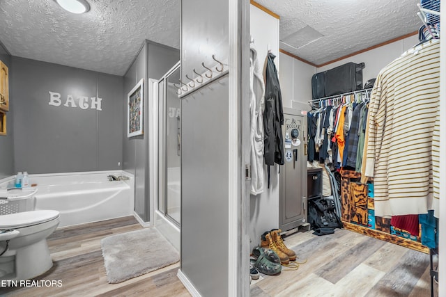 bathroom with separate shower and tub, crown molding, a textured ceiling, toilet, and hardwood / wood-style flooring