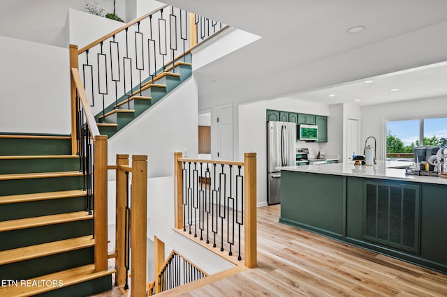 stairs with hardwood / wood-style flooring