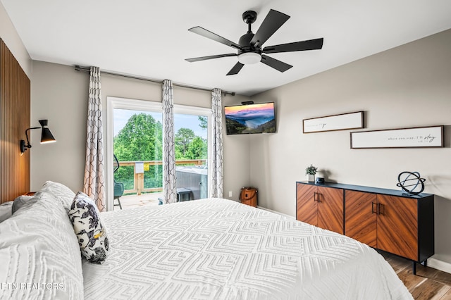 bedroom featuring access to outside, ceiling fan, and hardwood / wood-style flooring