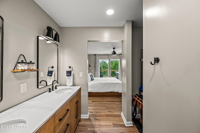 bathroom with hardwood / wood-style flooring, ceiling fan, and vanity