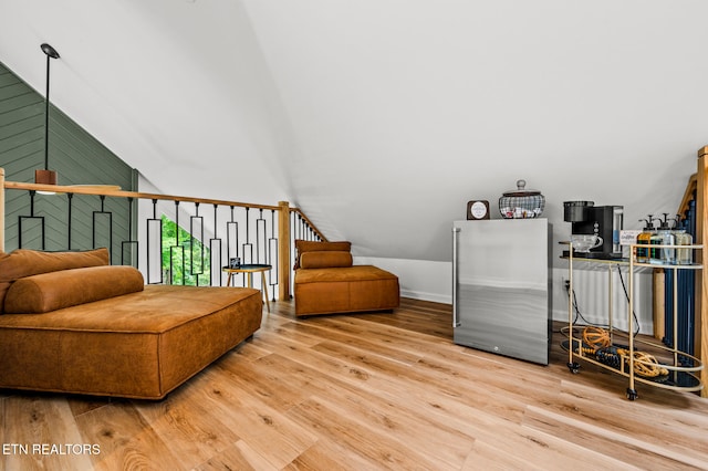 sitting room with lofted ceiling and wood-type flooring