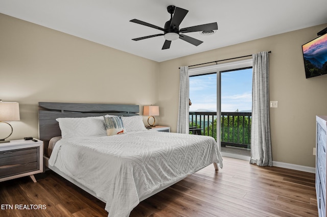 bedroom with ceiling fan, dark wood-type flooring, and access to outside