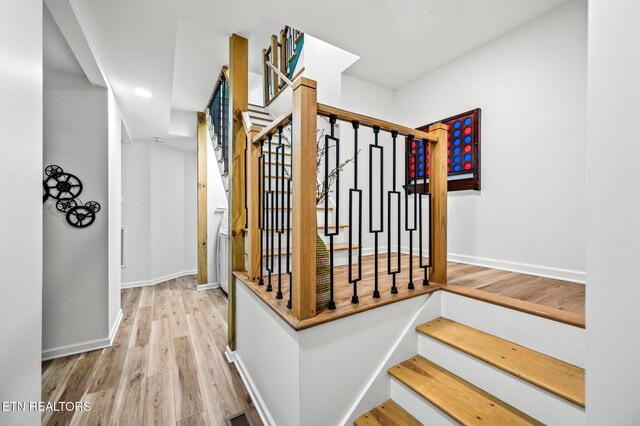 staircase with wood-type flooring