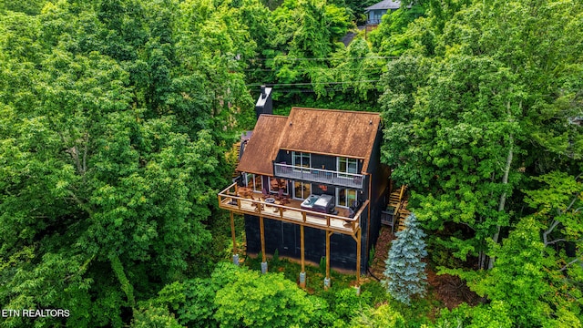 rear view of property with a wooden deck and a balcony