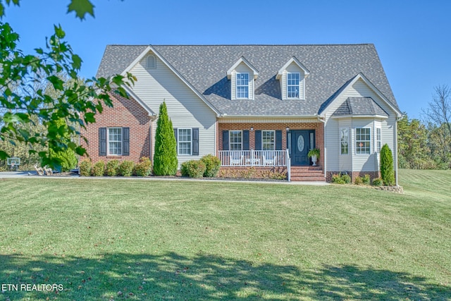 cape cod home with a porch and a front lawn