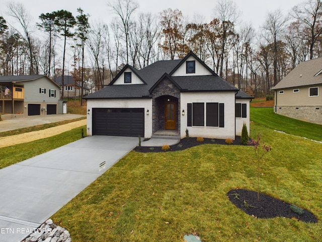 view of front of property with a front lawn and a garage