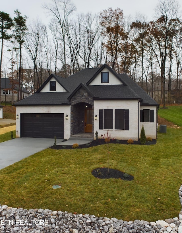 view of front of home with a front yard and a garage