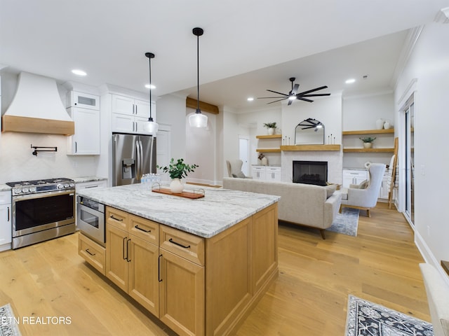 kitchen featuring stainless steel appliances, light wood finished floors, white cabinets, and custom range hood