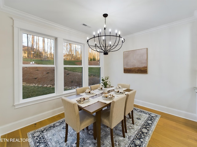 dining area featuring a wealth of natural light, visible vents, and wood finished floors