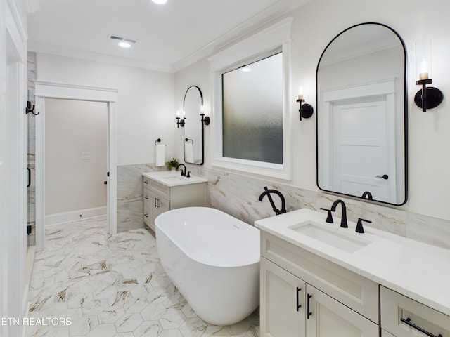 full bathroom with marble finish floor, visible vents, ornamental molding, a sink, and a freestanding tub