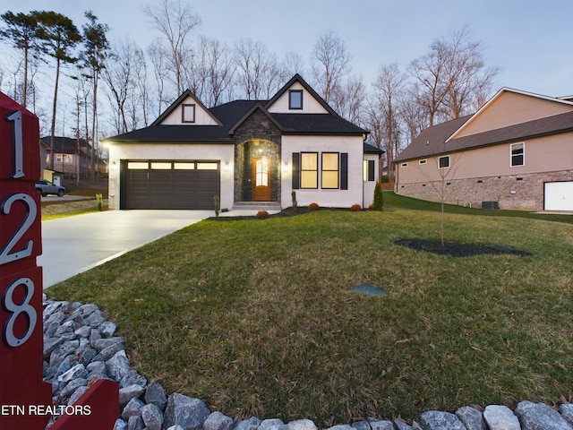 view of front of home with stone siding, concrete driveway, an attached garage, and a front lawn