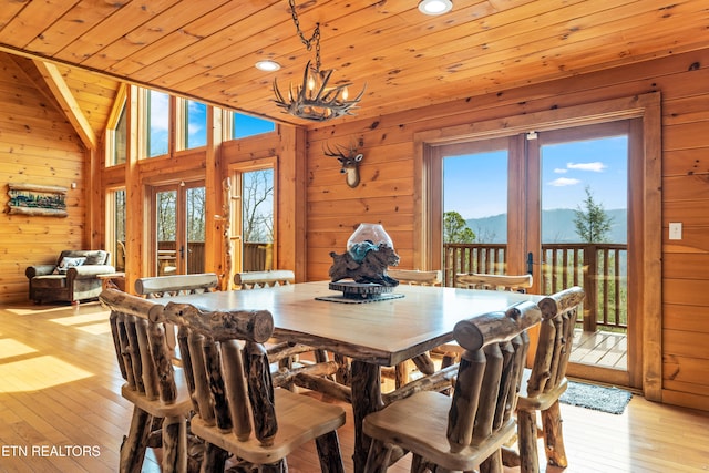 dining area featuring a mountain view, wooden ceiling, lofted ceiling, french doors, and light hardwood / wood-style floors